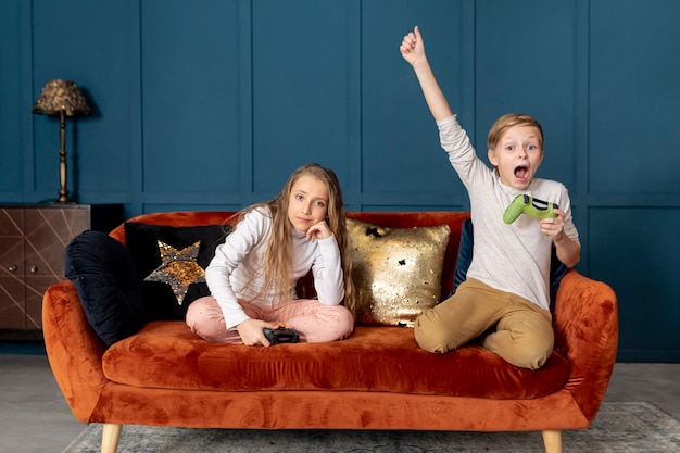 Free photo boy winning at playing video games with his sister