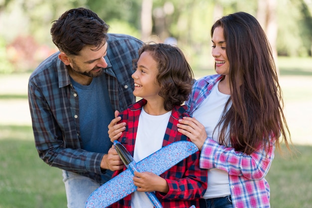 Free photo boy with airplane and parents at the park together