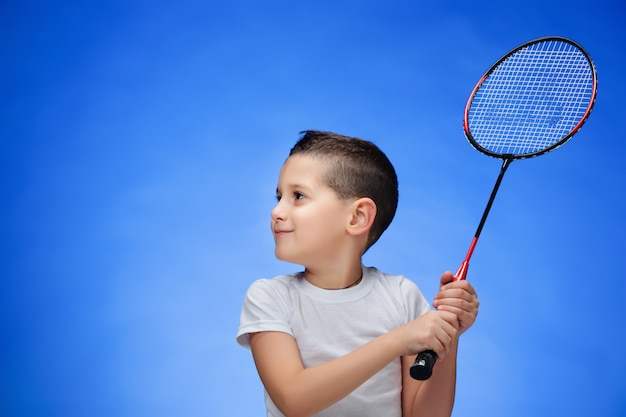 boy with badminton rackets outdoors