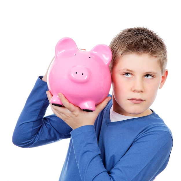 Boy with big pink piggy bank on white space