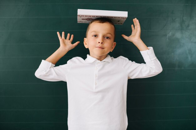 Boy with book on head