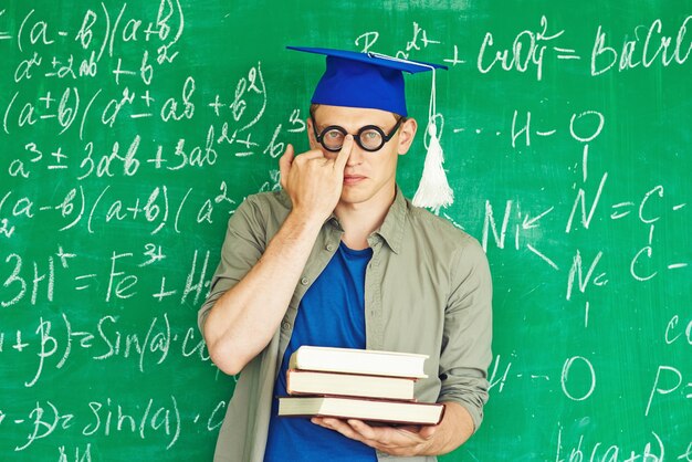 Boy with books on his left hand