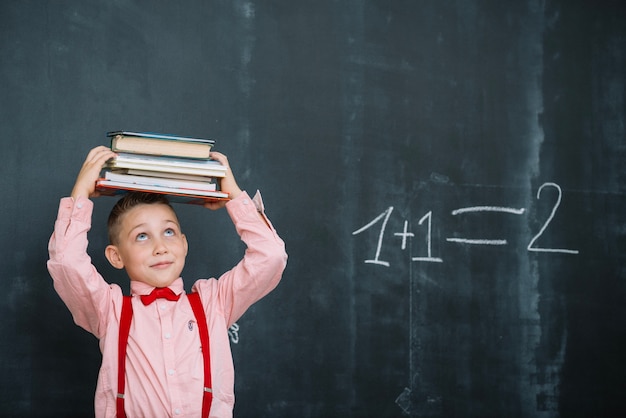 Boy with books in math class