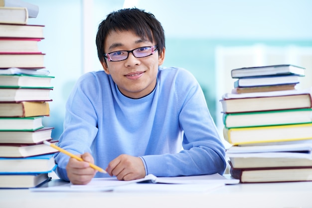 Boy with glasses in the library