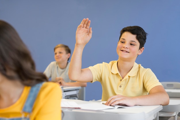 Boy with hand raised