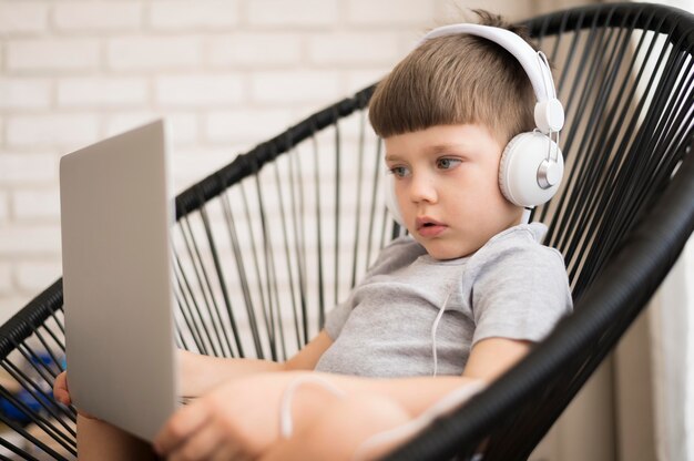 Boy with headphones and laptop