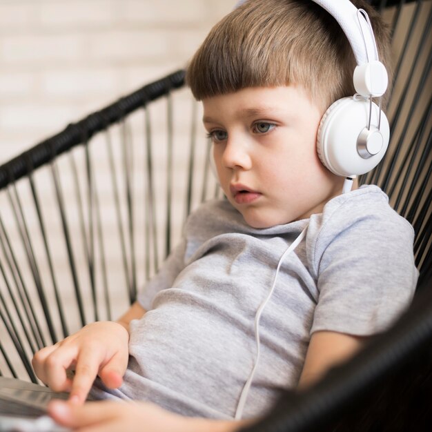 Boy with headphones on laptop