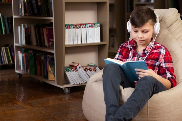 Мальчик с наушниками читает