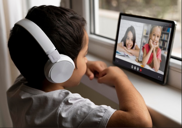 Boy with headphones talking to his friends in video call