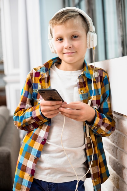 Boy with headphones using smartphone