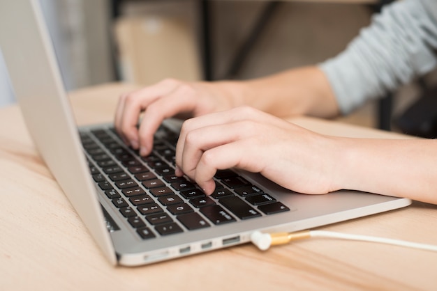 Boy with laptop in office