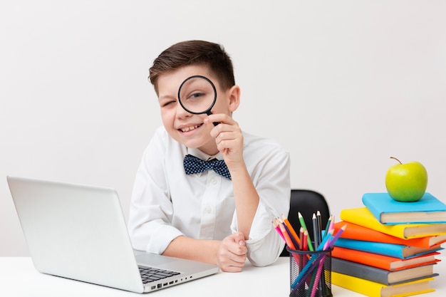 Boy with magnifier reading