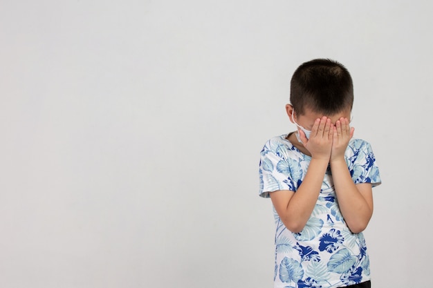 boy with mask posing on white background