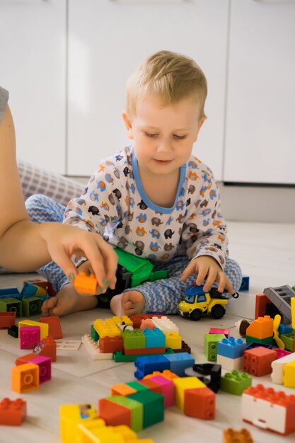 boy with mom playing in colorful building kit