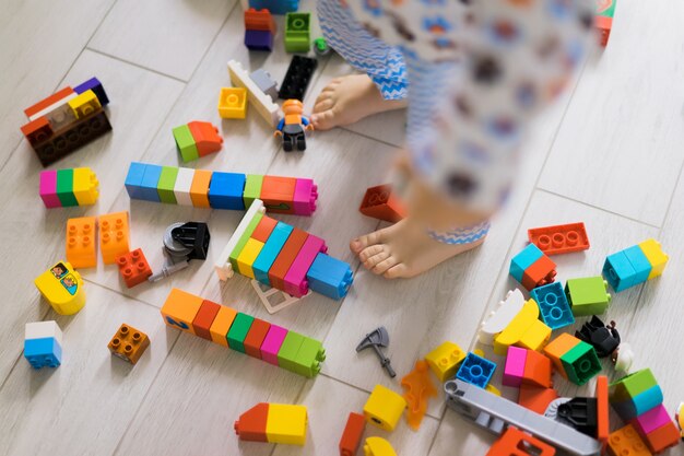 boy with mom playing in colorful building kit