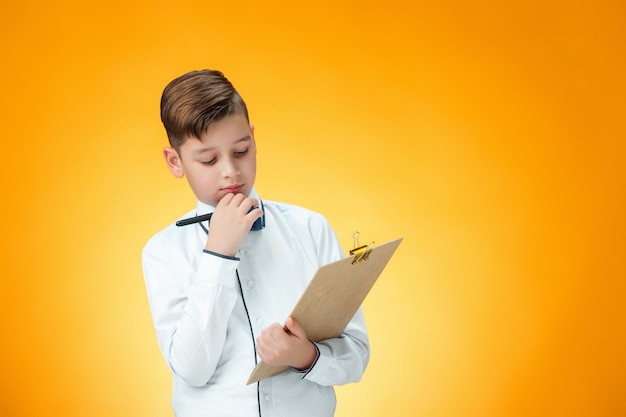 The boy with pen and tablet for notes