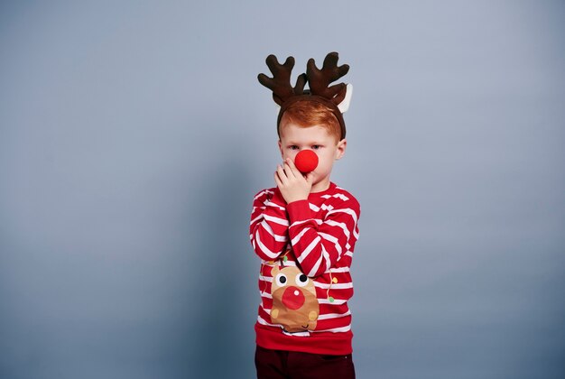 Boy with reindeer antlers and red nose