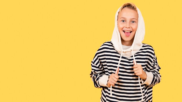 Boy with tongue out wearing hoodie