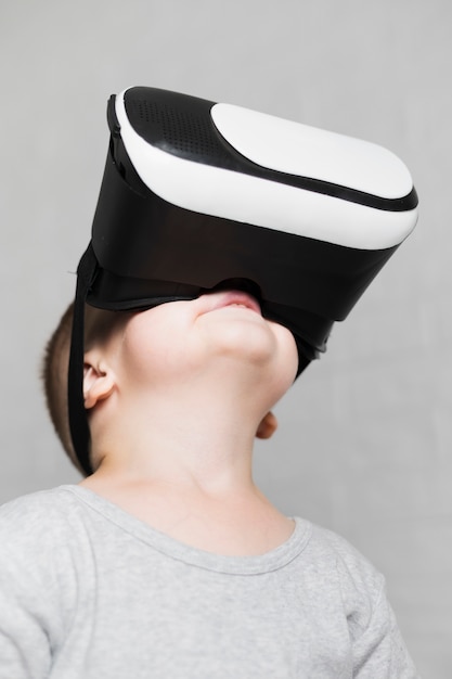 Boy with virtual headset looking up 