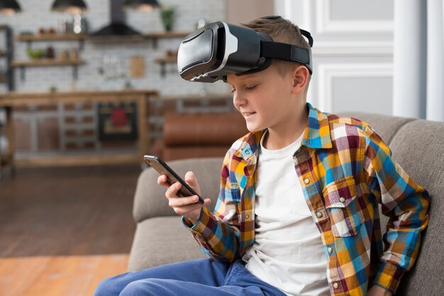 Boy with vr headset and smartphone