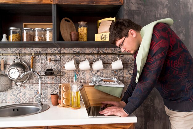 Boy working on grey laptop