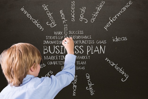 Boy writing on a blackboard