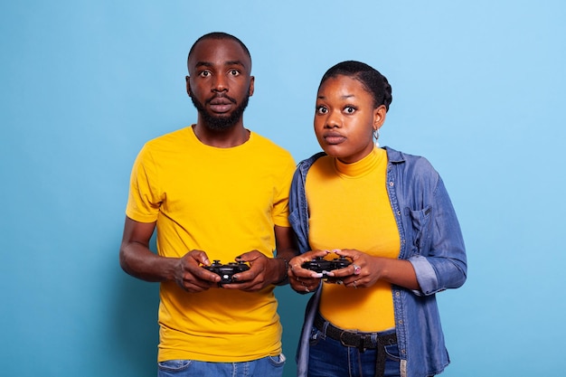 Free Photo  Boyfriend and girlfriend playing video games with controller  on console. modern couple holding joystick to play online game together,  using accessories to have fun. leisure activity