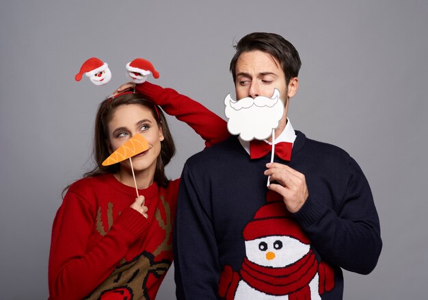 Boyfriend and girlfriend with Christmas masks