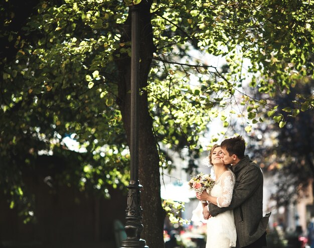 Boyfriend hugging his girlfriend from behind and kissing her