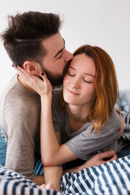 Boyfriend kissing his girlfriend forehead close-up