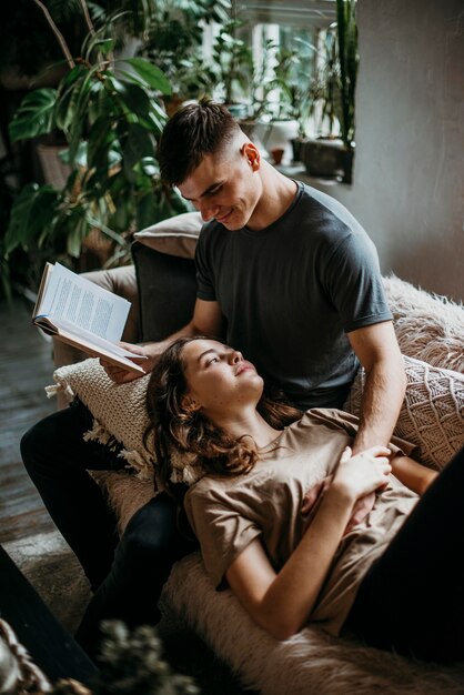 Boyfriend reading a love story for his girlfriend