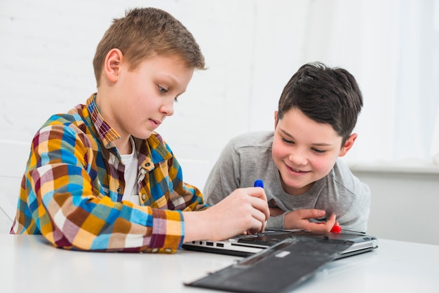 Boys fixing laptop