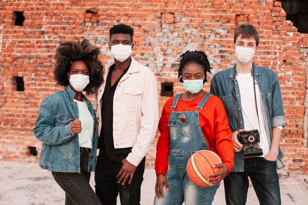 Boys and girls posing with surgical masks