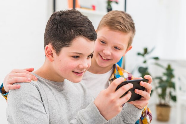 Boys playing with smartphone