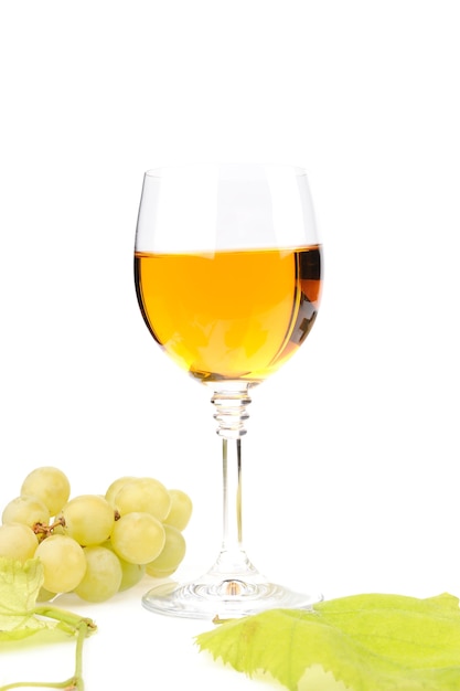 Branch of grapes and glass of wine isolated on white