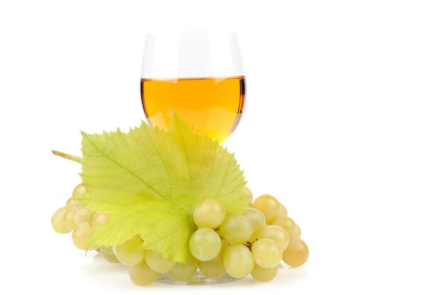 Branch of grapes and glass of wine isolated on white
