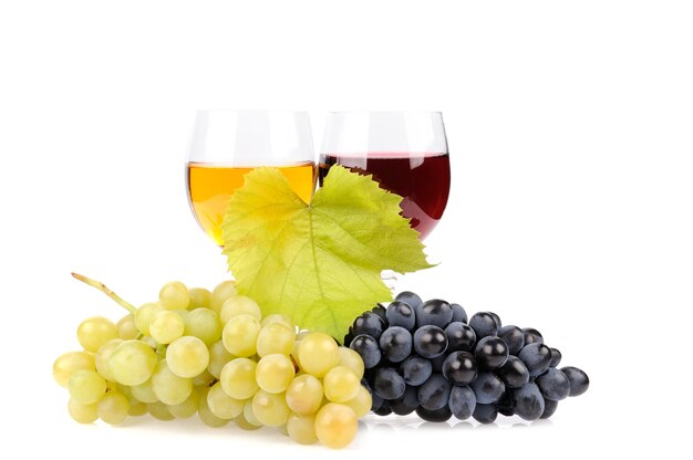 Branch of grapes and glass of wine isolated on white