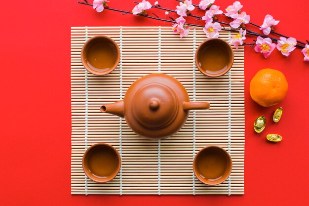 Branch near tea ceremony supplies on napkin