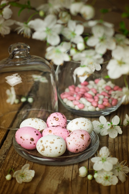 Branch Of Spring Flowers And Colorful Pink Candy Eggs For Easter On Rustic