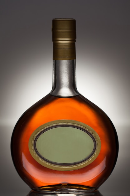 Free photo brandy bottle in oval bottle