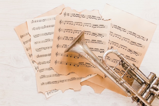 Free photo brass trumpet on sheet music