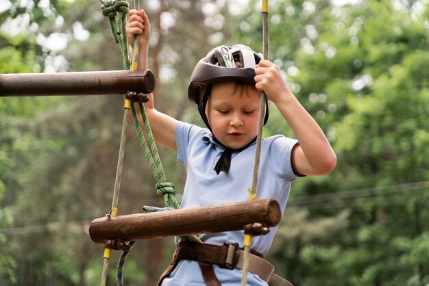 Brave boy having fun at an adventure park