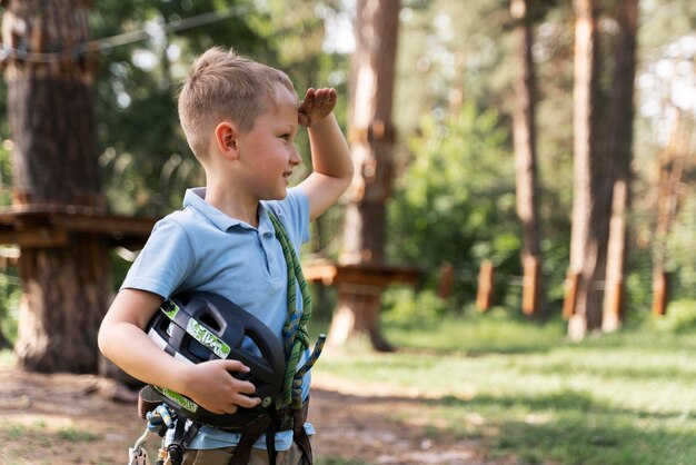 Brave boy having fun at an adventure park