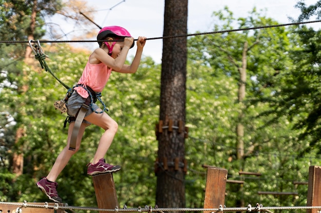 Brave girl having fun at an adventure park