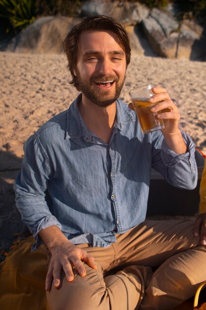 Brazilian man having guarana drink outdoors