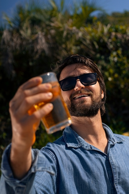 Free photo brazilian man having guarana drink outdoors