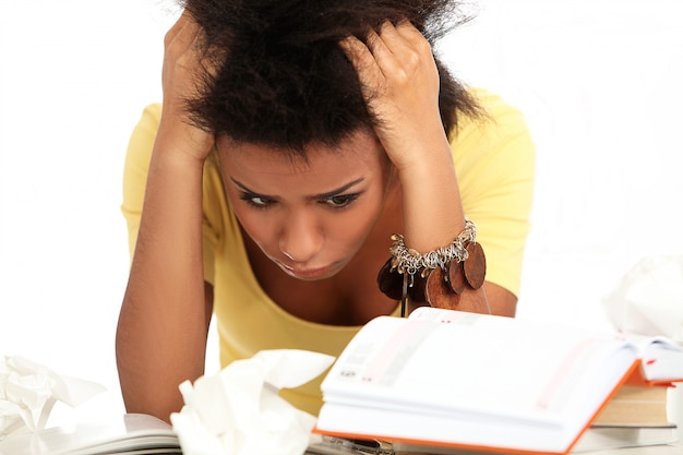 Brazilian young woman stressed with books