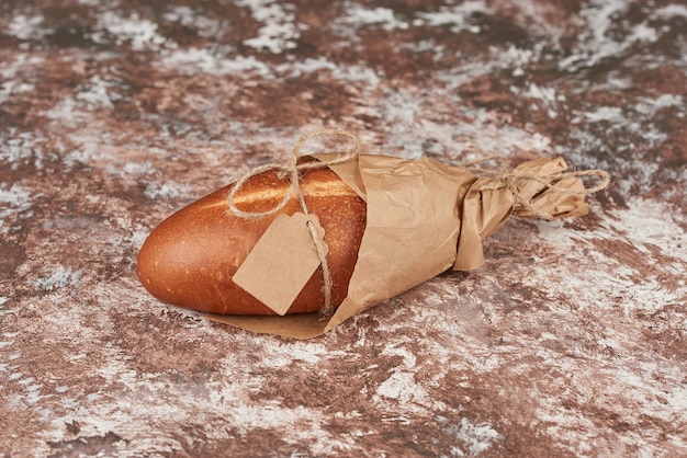 Bread buns on the marble in a paper wrap.