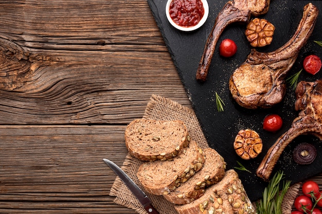 Bread and cooked meat on wooden board