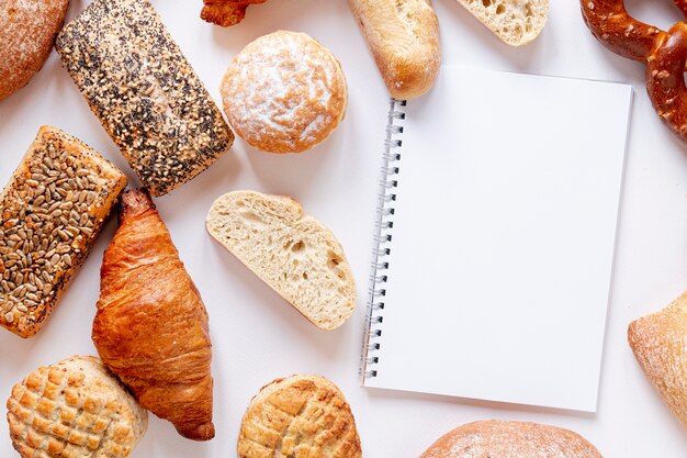 Bread and croissants near a notebook